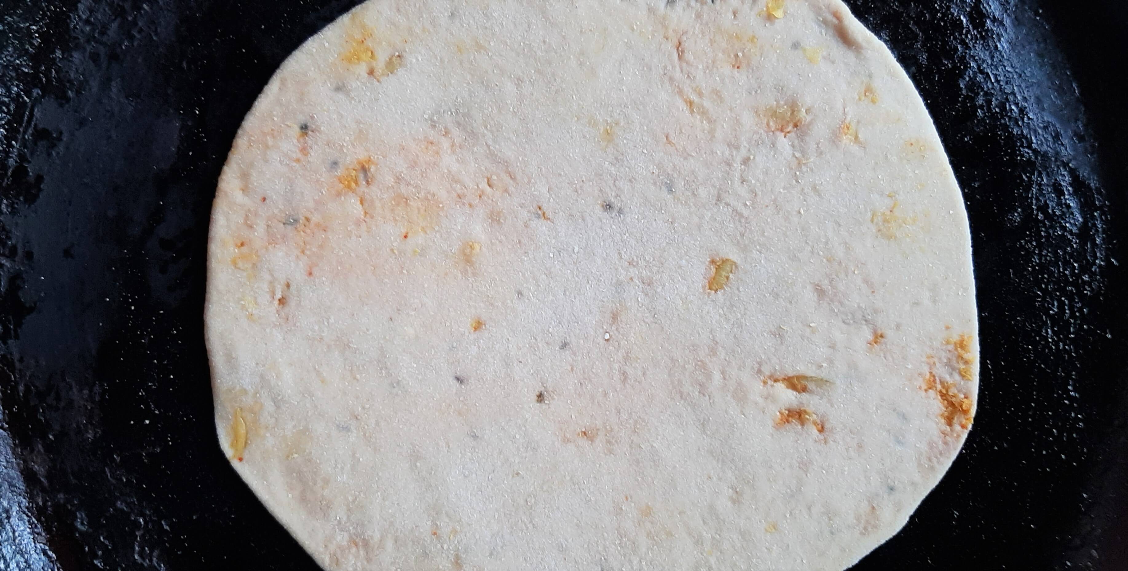 Cabbage paratha on a pan