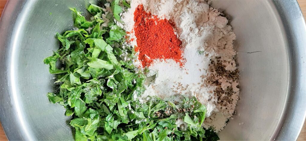 chopped methi leaves and wheat flour with spices