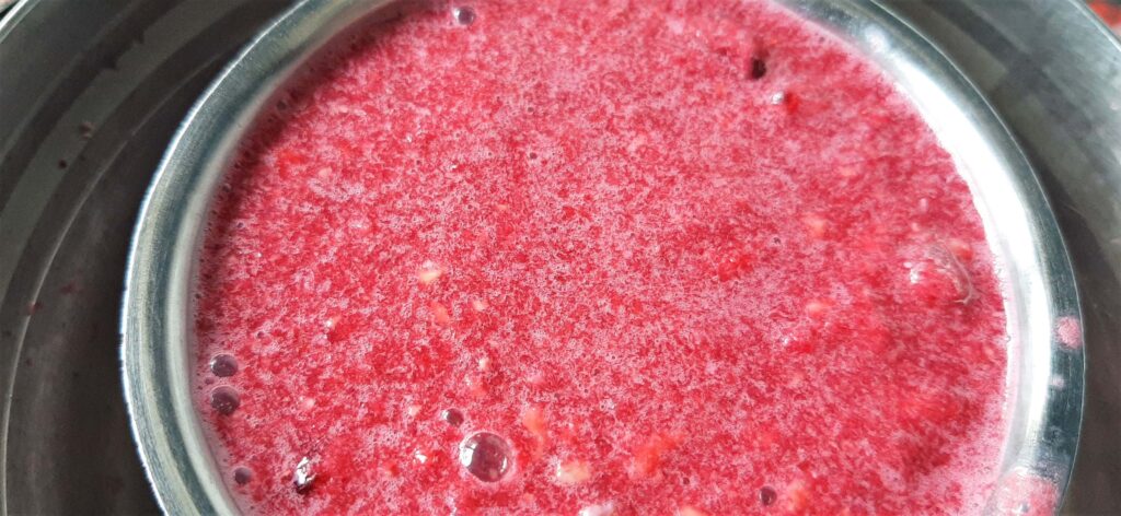 straining pomegranate juice