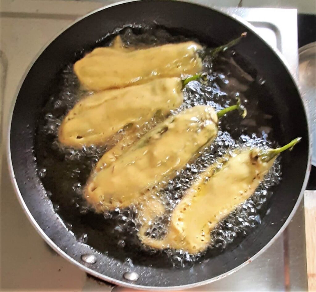 Frying bharli mirchi pakora