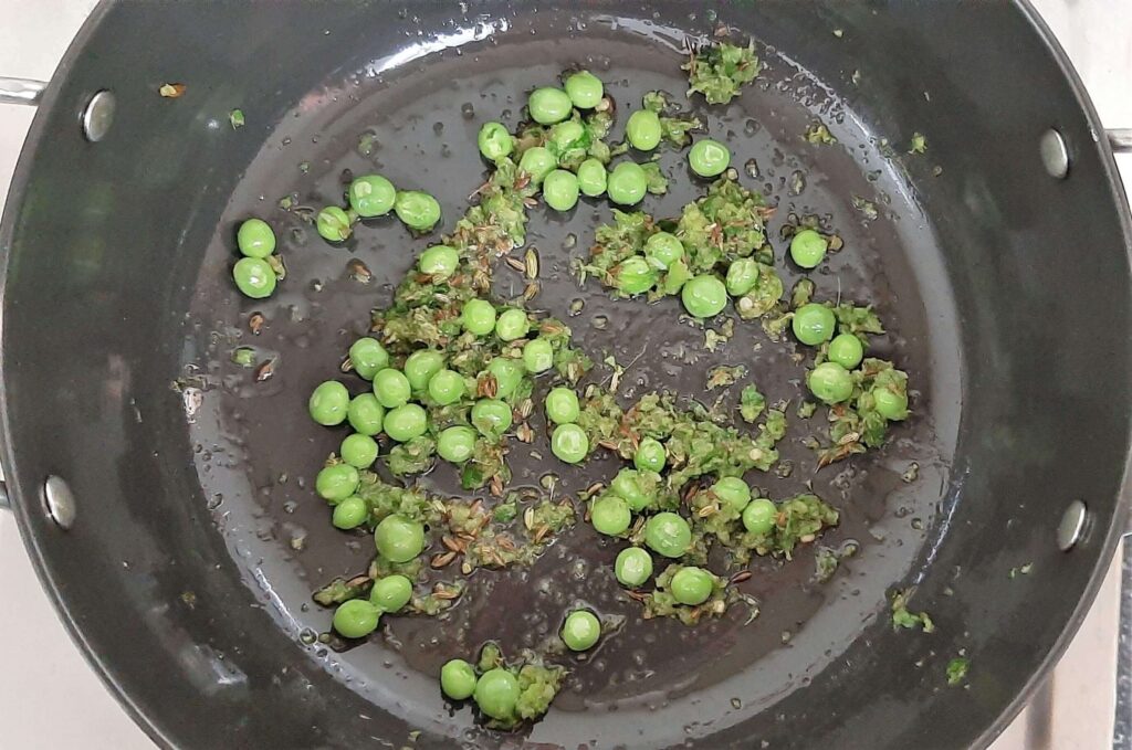sauteing peas for samosa filling